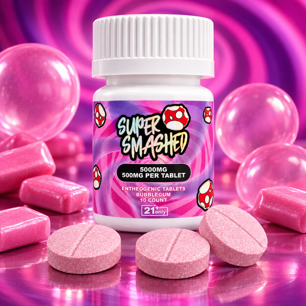 Super Smashed Bubblegum tablets in a white bottle with a pink and purple label, surrounded by pink tablets and bubblegum pieces.